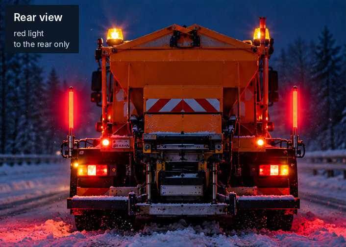 Winter maintenance vehicle from the rear at night: light rods shine red to the rear and mark the vehicle width